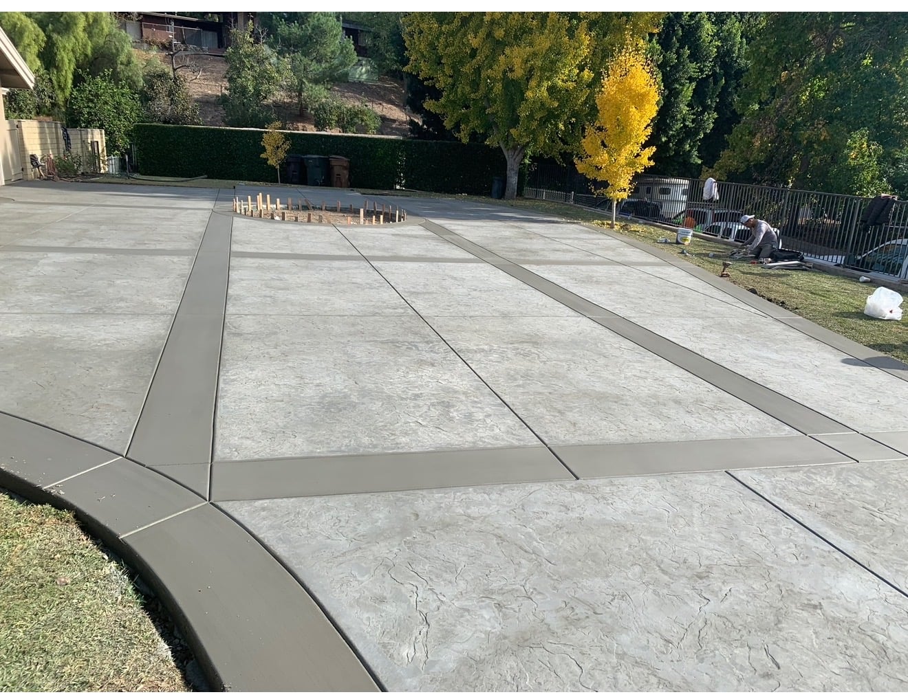 Stamped concrete driveway with smooth borders and curved curb